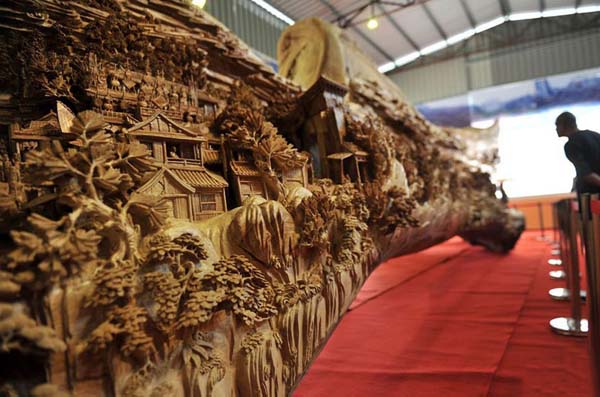 The piece won the Guinness World Record for the longest wooden carving and measures over 40ft (specifically, it is 12.286 meters long, is 3.075 meters tall at it highest point, and is also 2.401 meters wide).